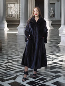 Black mink coat, long mid-calf length with textured fur and full-length sleeves.