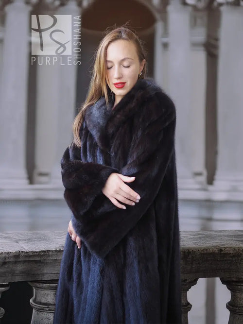Black mink coat with plush collar and long sleeves, side view