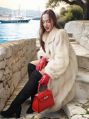 Cream mink fur coat with open front and long sleeves, plush fluffy look