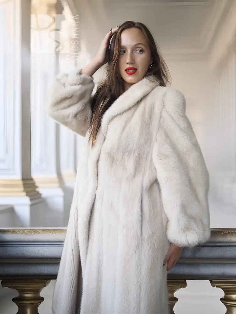 White fur coat with wide collar, long sleeves, knee-length, front view with one hand on hair
