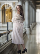 White fur coat with wide collar, long sleeves, knee-length, side view with arms crossed