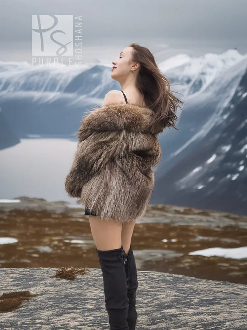 Brown faux-fur jacket with high collar and long sleeves, styled over a black dress.