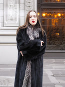 Black mink coat with silver fox collar, arms crossed and open front