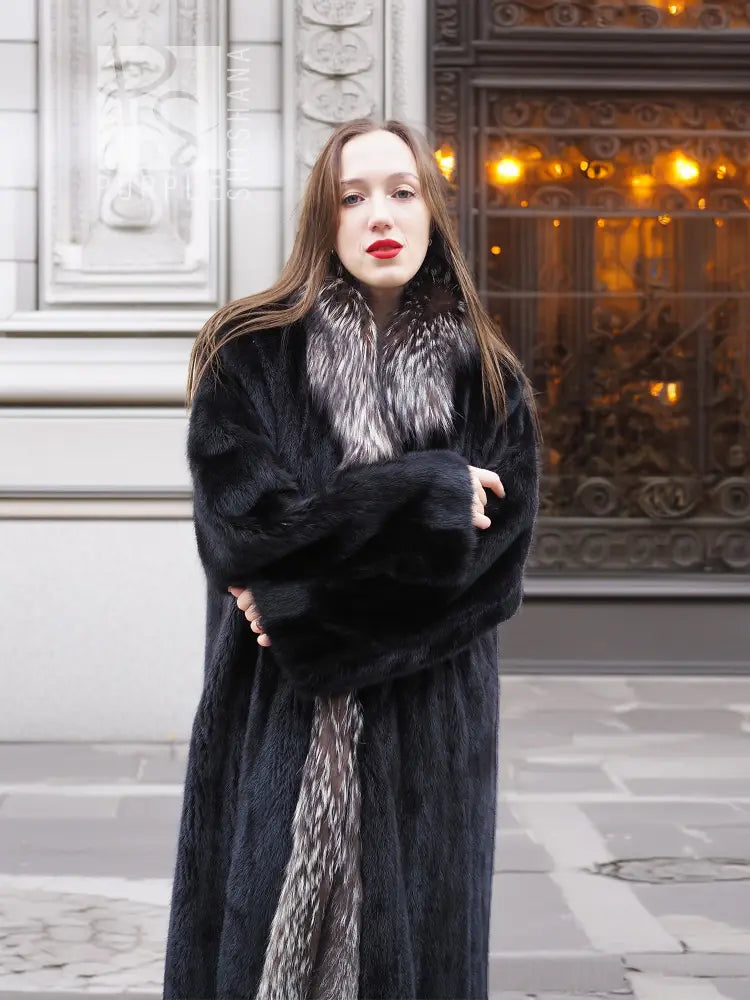 Black mink coat with silver fox collar, arms crossed and open front