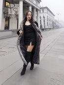 Black mink coat with silver fox collar, worn over black dress and boots