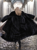 Back view of black mink coat with silver fox fur collar detail