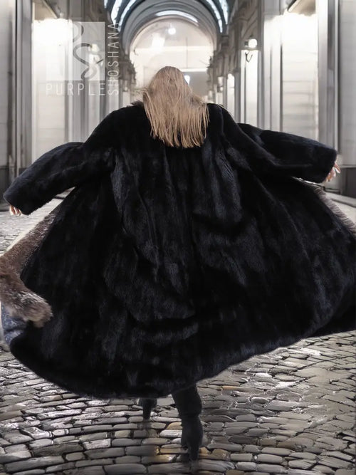 Back view of black mink coat with silver fox fur collar detail