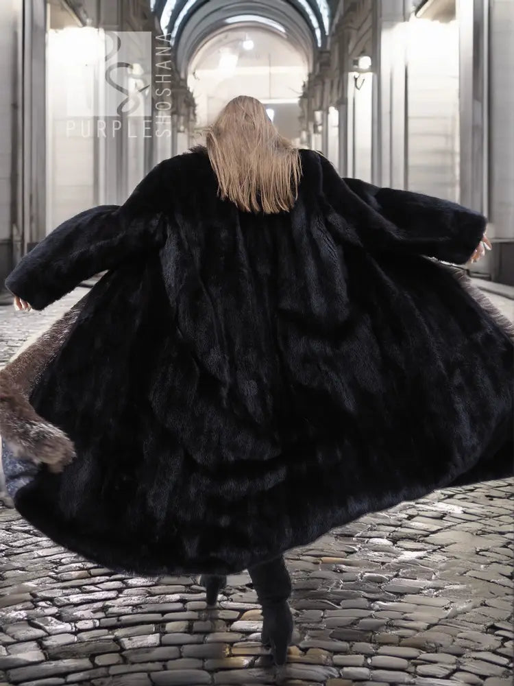 Back view of black mink coat with silver fox fur collar detail