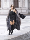 Black mink coat draped over a dress, with silver fox fur collar