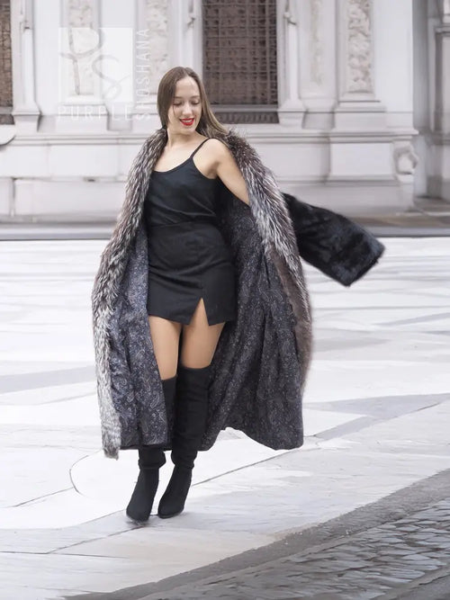 Black mink coat draped over a dress, with silver fox fur collar