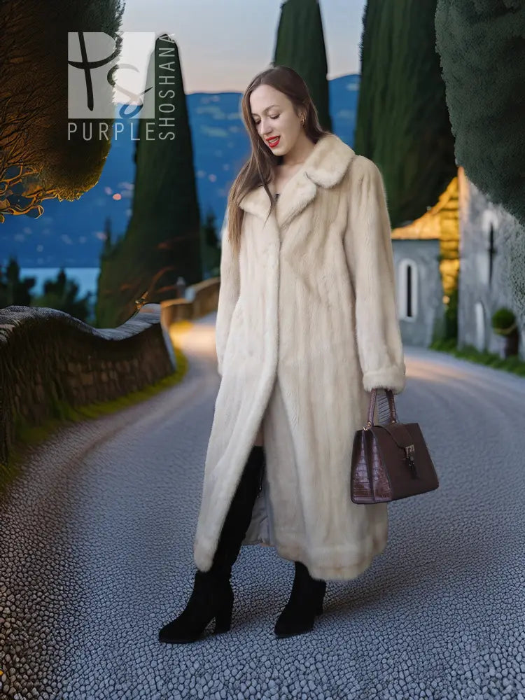 Ivory mink fur coat with shawl collar and long sleeves, relaxed standing pose