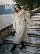Light cream fur coat with pointed collar, long sleeves, and front button closure.