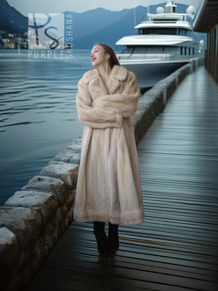 Cream long fur coat with thick collar and button closure, styled with tall black boots.