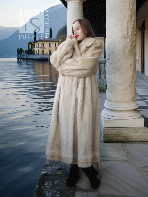 Light cream mink fur coat with wide collar and full-length button-front styling.