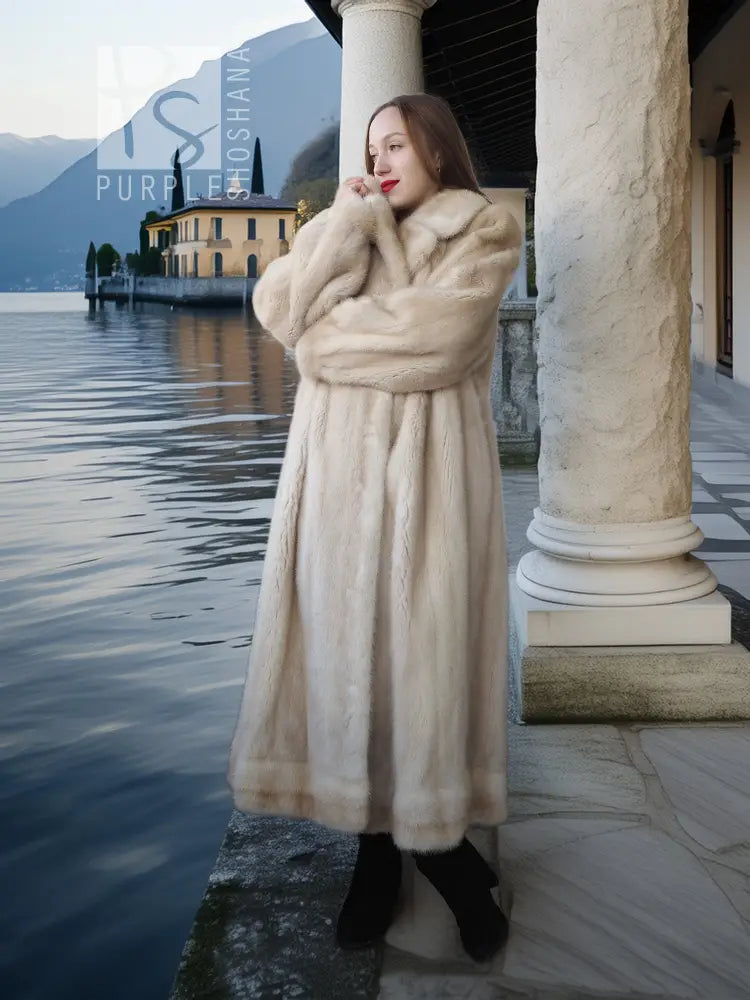 Light cream mink fur coat with wide collar and full-length button-front styling.