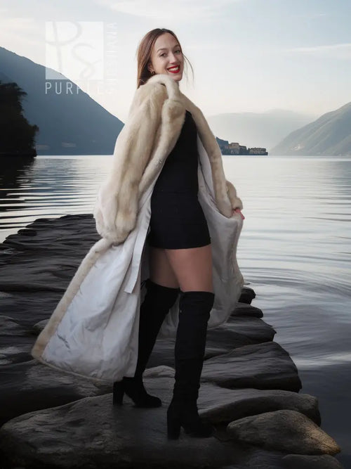 Cream fur coat draped over shoulders, open front showing a fitted black dress.