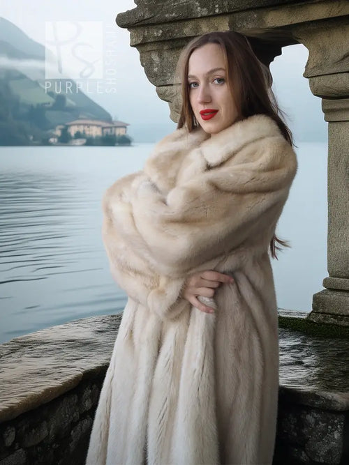Cream fur coat with plush collar and buttoned front, close-up view of upper body.