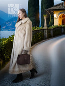 Ivory mink fur coat with shawl collar, long hem and textured fur, side profile