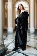 Black mink full-length coat with plush texture, wide cuffs, and belt tie