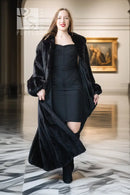 Black mink coat with open front and rounded fur collar, full-length hem