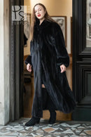 Black mink full-length coat with high collar and button front; front view from doorway.