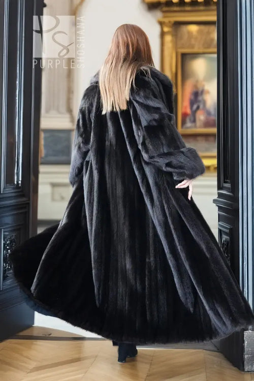 Black mink full-length coat with high collar and wide sleeves; back view.