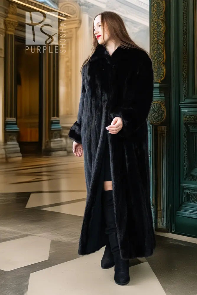 Black mink coat, full length, high collar and button front; angled side profile.