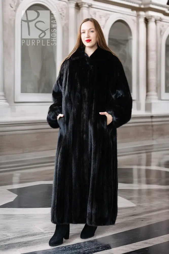 Black mink full-length coat with button front and high collar, long sleeves.