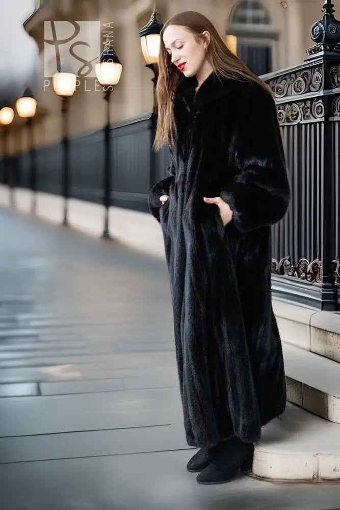Black mink full-length coat with high collar and button front; three-quarter side view.