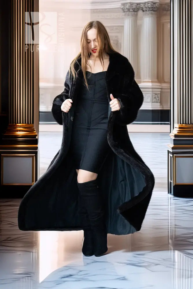 Black mink full-length coat with open front, broad collar, and flowing drape