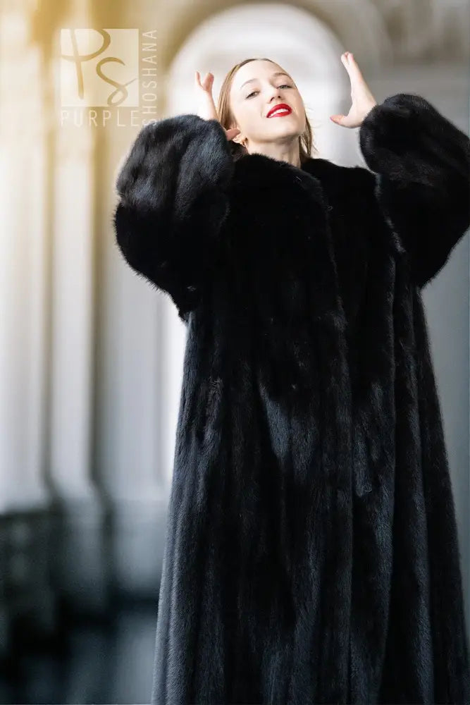 Black mink coat with high fur collar and voluminous sleeves, open and draped