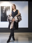 Dark mink fur jacket with gray fox-fur trim and striped sleeves, open front.