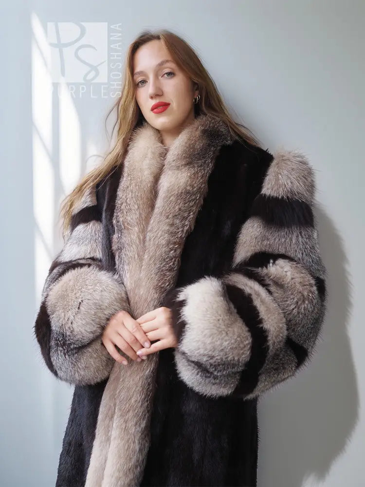 Dark mink jacket with long fur collar and gray, black and white striped cuffs