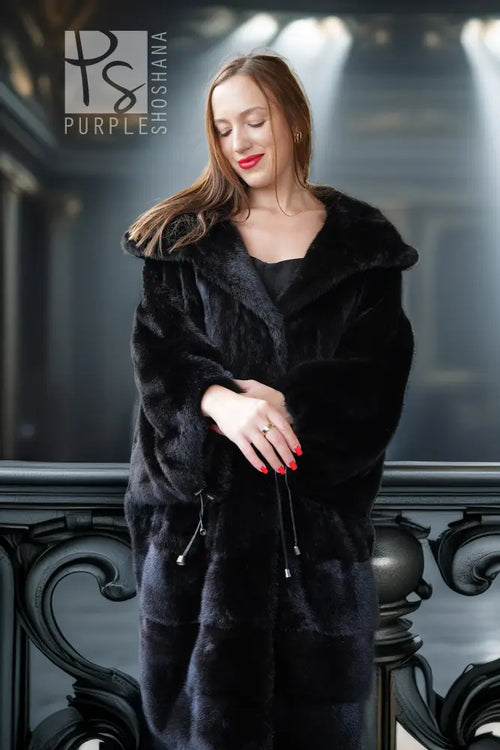 Black hooded mink coat with open front and zip ties, side view