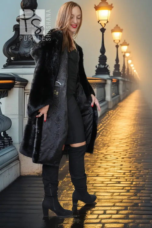 Black hooded mink coat with front zipper tabs, walking side view