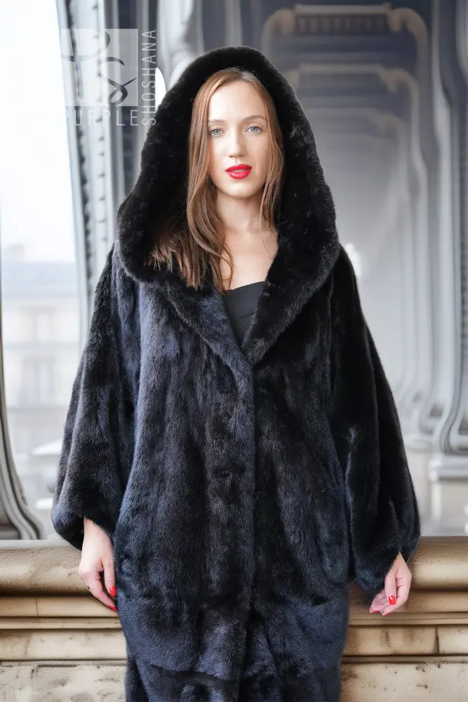Black hooded mink coat with structured shoulder shape and long length