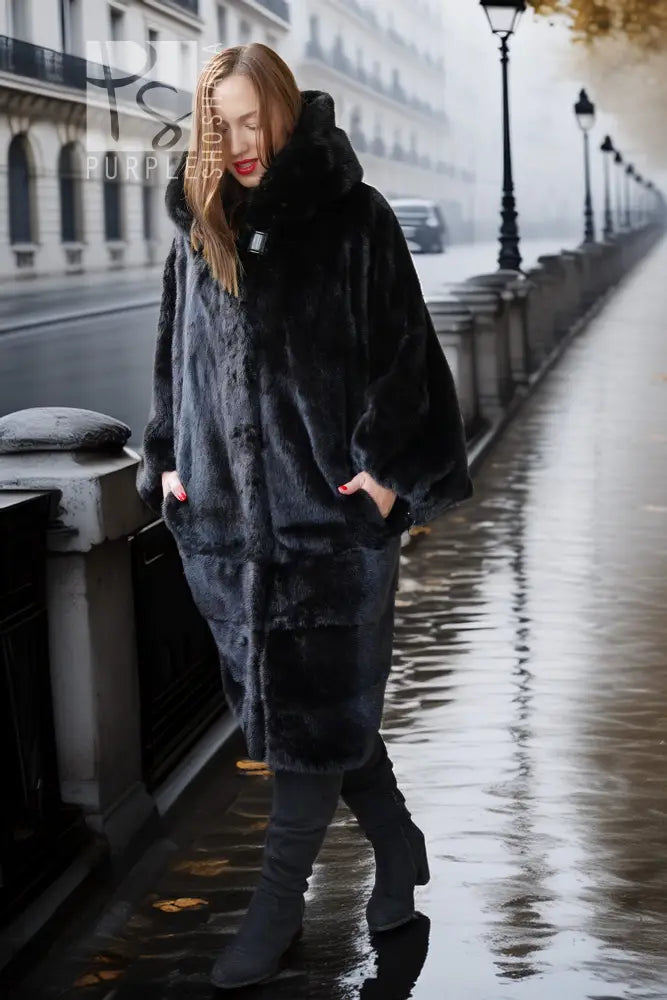 Black hooded mink coat with voluminous sleeves and front pockets, full-length look