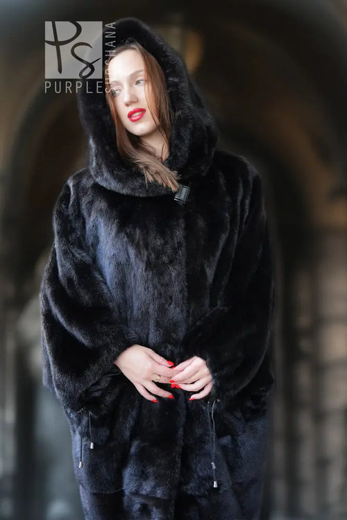 Black hooded mink coat with full-length fur texture, hands near midsection