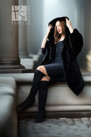 Black hooded mink coat with soft fur texture, open front, worn with tall black boots.