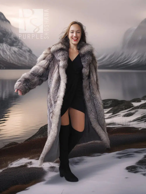 Fox fur coat with shawl collar, long gray fur silhouette over black dress and tall boots
