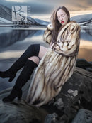 Long fur coat with oversized striped fur collar, beige-brown tone, front three-quarter view.
