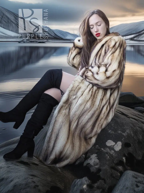 Long fur coat with oversized striped fur collar, beige-brown tone, front three-quarter view.