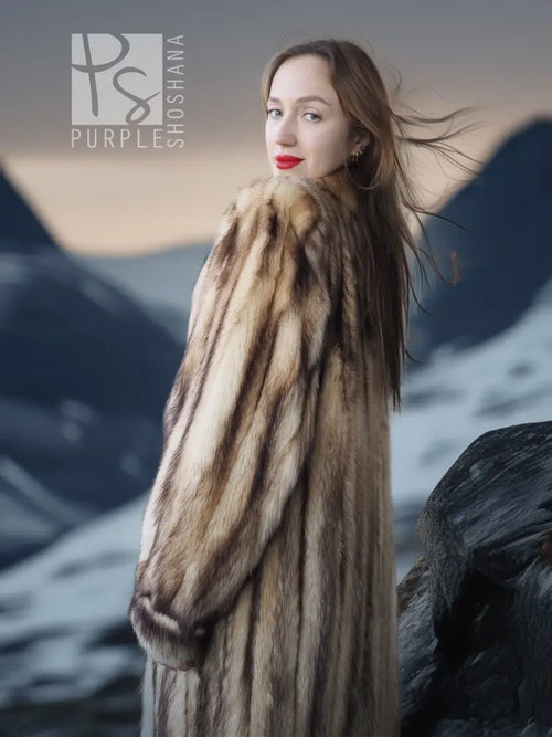 Long fur coat in beige-brown striped fur, side profile with defined waist and cuffs.