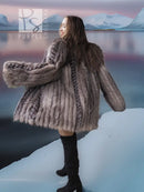 Platinum silver fox fur jacket with long sleeves and flared hem over black boots