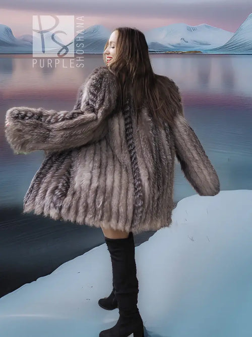 Platinum silver fox fur jacket with long sleeves and flared hem over black boots