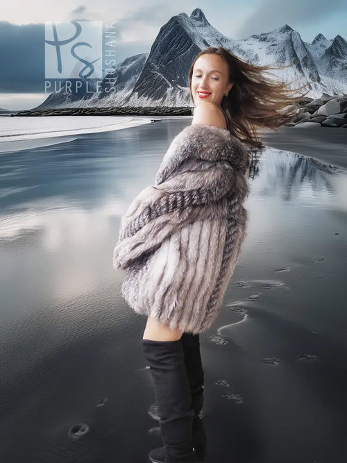 Platinum silver fox fur jacket with textured fur collar over a black dress and boots