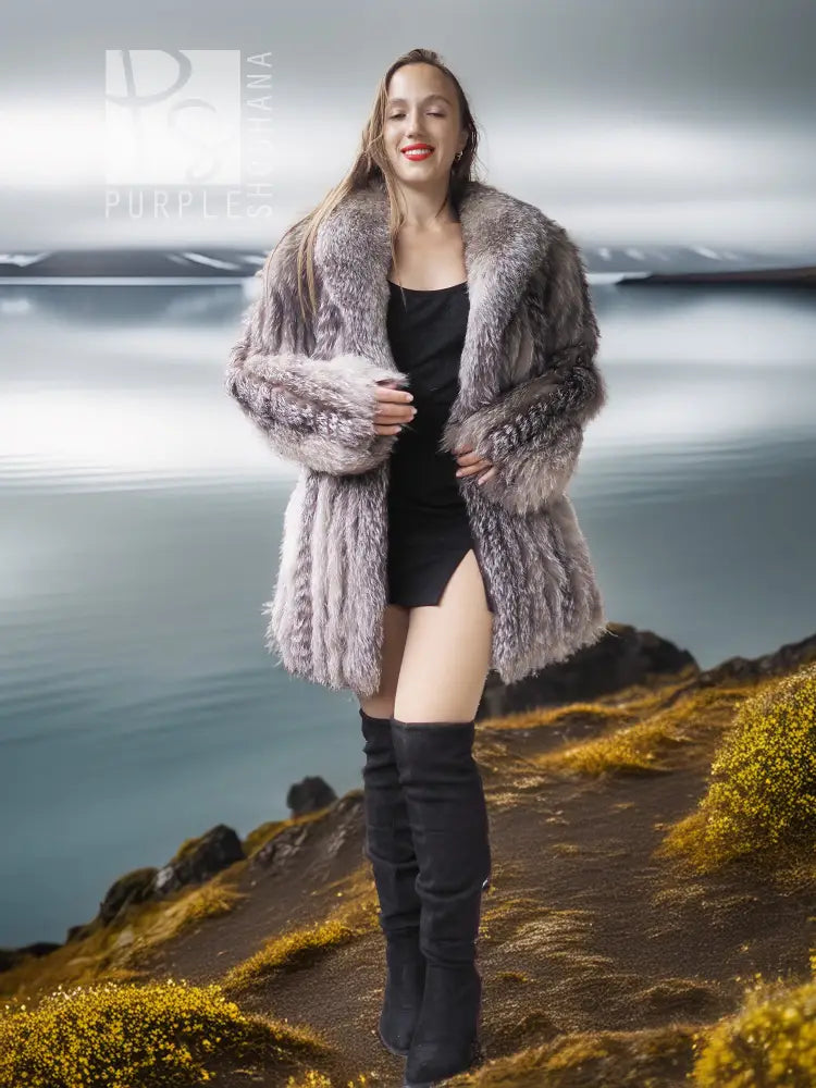 Platinum silver fox fur jacket with fringe sleeves over a black dress and boots