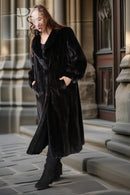 Long dark mink coat with voluminous sleeves and front buttons, side view