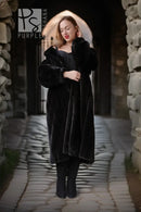 Black fur coat with button-front, long sleeves, mid-calf length, front view with arms folded.