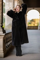 Long dark mink coat with wide sleeves and button front, standing full view